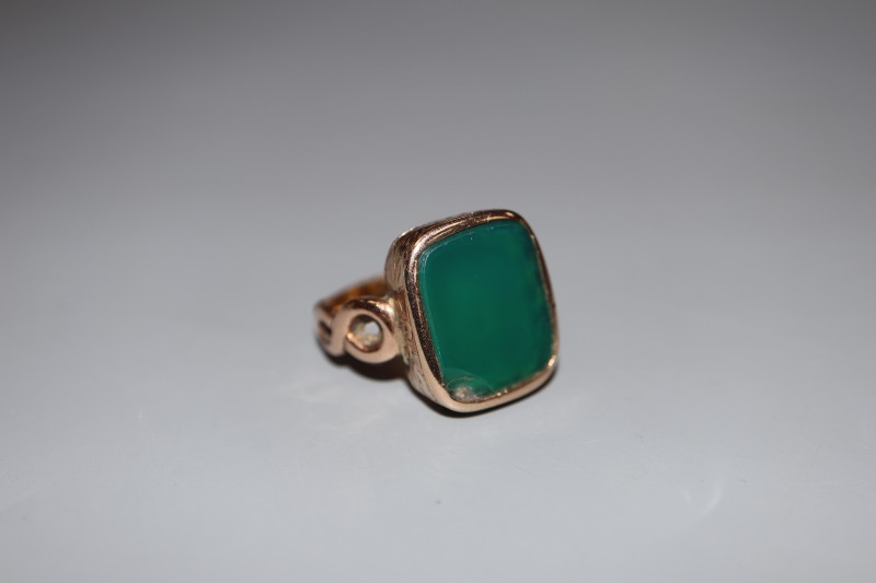 A 19th century yellow metal and chrysophase? set signet ring, size M, gross 7.2 grams.